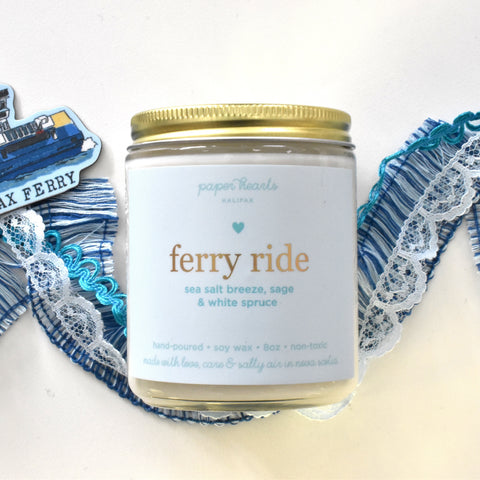 Ferry ride candle in a jar scented like sea salt breeze, sage, and white spruce. 
