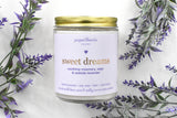 Sweet dreams candle in a jar surrounded by bouquets of lavender. 